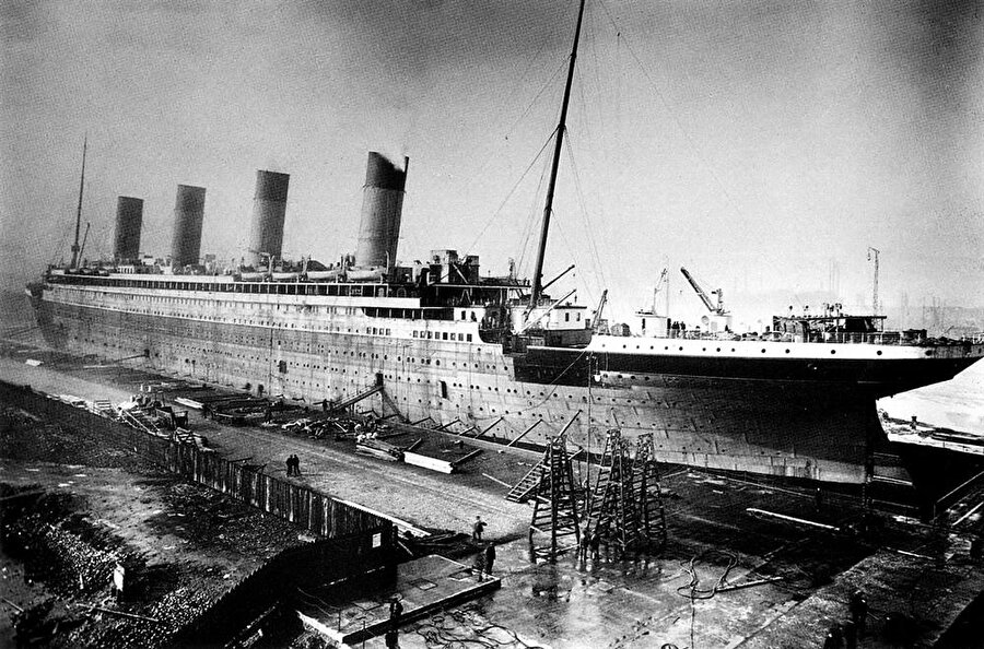 14 Nisan 1912’de buz dağına çarptı
Titanic, 268 metre uzunlukta, 4 bacalı, 11 katlı, 46 bin ton ağırlığında, içinde yüzme havuzları, Türk hamamı, dans salonları olan, çok lüks bir gemiydi. Geminin biletleri ‘Tanrının bile batıramayacağı gemi’ sloganıyla satılıyordu. Ta ki gemi, ilk yolculuğunun dördüncü gününde, 14 Nisan 1912 akşamı bir buz dağına çarpana kadar. Titanic o gece yarısından sonra 3657 metre derine gömüldü. Yolcularından 1517’si ise hayatını kaybetti.(Kaynak: Hürriyet)