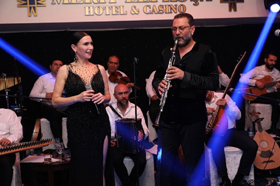 Hüsnü Şenlendirici hakkında
12 Temmuz 1976 tarihinde Bergama‘da doğdu. 5 yaşında klarnet çalmaya başladı. Dedesinin verdiği klarnet ile ilk “Harmandalı“ çalmayı öğrendi. 1988 yılında başladığı İstanbul Teknik Üniversitesi Türk Müziği Devlet Konservatuvarı Çalgı Eğitim Bölümünü, İngilizce yüzünden terk etti.
Vurmalı çalgılar ustası Okay Temiz‘in “Magnetic Band” grubu ile yüzlerce festivalde Türkiye’yi temsil etti. Babası Ergun Şenlendirici’nin 6 kişilik grubu “Laço” ile yurtdışında birçok önemli festivallere de katıldı.