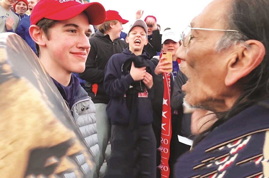 Kızılderili yaşlı adamla dalga geçen ırkçılar 'Trump 2020' sloganları attı.