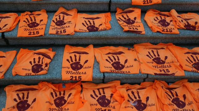 Orange t-shirts placed to honour Indigenous children buried at Kamloops residential school are seen outside the British Columbia Parliament Building in Victoria, British Columbia, Canada on June 30, 2021.