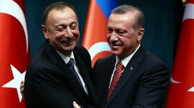 Turkish President Recep Tayyip Erdogan embraces his Azerbaijani counterpart Ilham Aliyev
