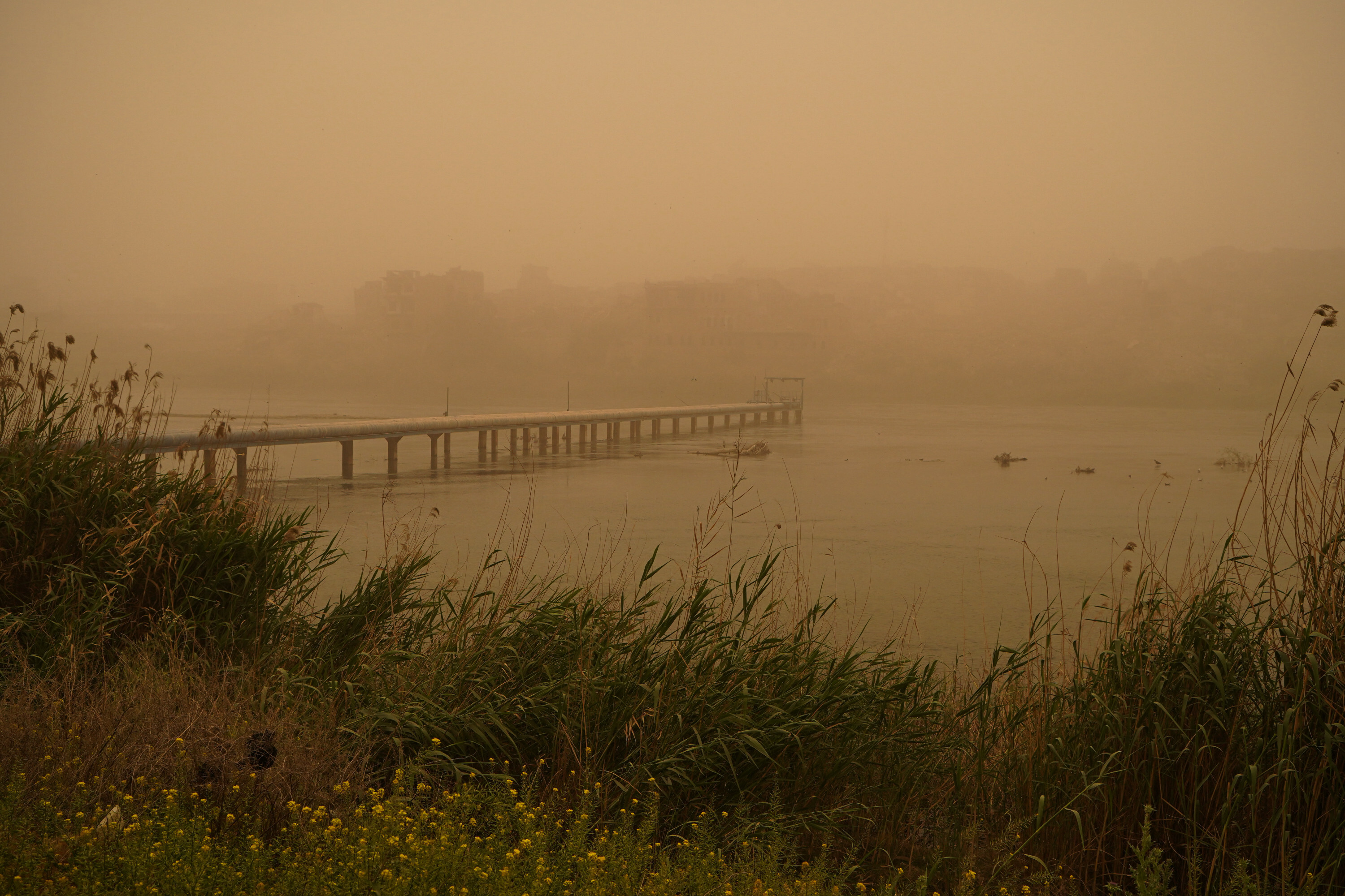 Mosul lake covered in orange haze as sandstorm batters Iraq