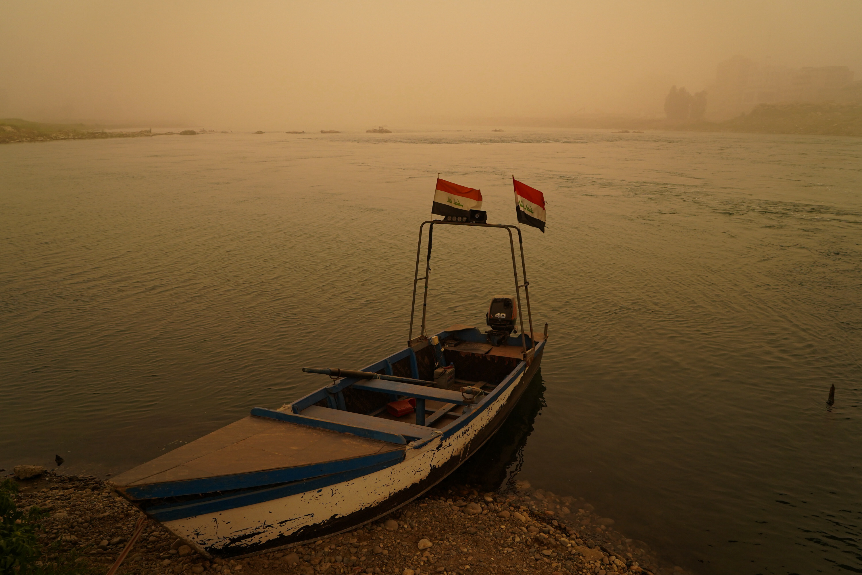 Mosul lake covered in orange haze as sandstorm batters Iraq