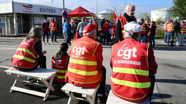 Des manifestants lors d’une manifestation devant la raffinerie Total Mardyck, près de Dunkerque, dans le nord de la France, le 18 octobre 2022. @ FRANCOIS LO PRESTI / AFP