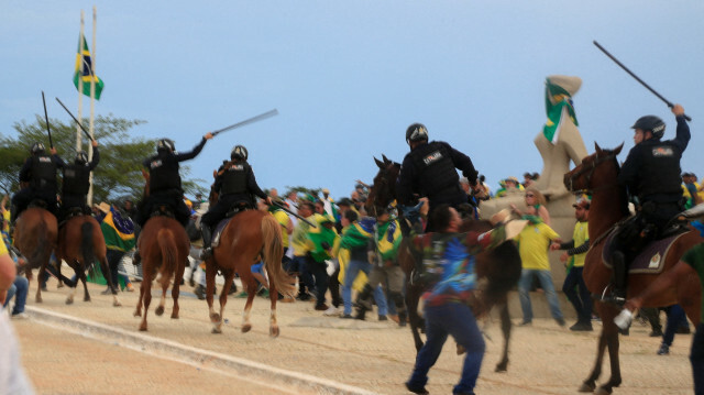 Les partisans de l'ancien président brésilien Jair Bolsonaro affrontent la police anti-émeute alors qu'ils envahissent le palais présidentiel du Planalto à Brasilia le 8 janvier 2023. Ils  ont fait irruption dans le Congrès, le palais présidentiel et la Cour suprême dimanche, lors d'une manifestation dramatique contre l'investiture du président Luiz Inacio Lula da Silva la semaine dernière. @AFP