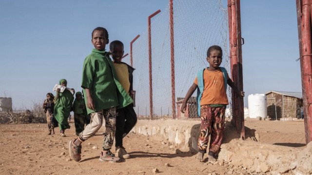 Les enfants marchent dans une école du camp pour personnes déplacées à l'intérieur du pays de Farburo dans le village d'Adlale, près de la ville de Gode, en Éthiopie, le 11 janvier 2023.