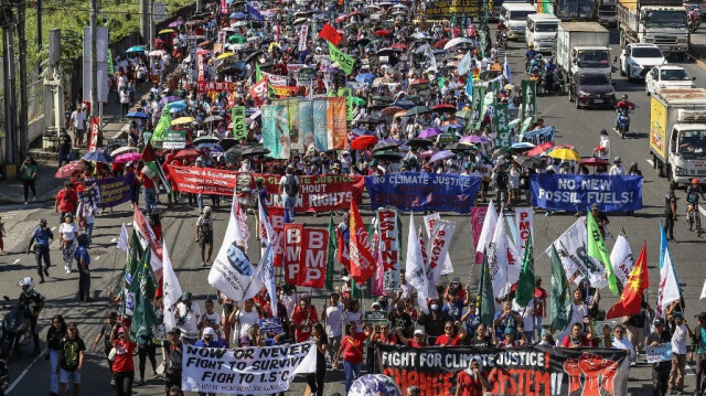 Des manifestants participent à la journée mondiale d'action pour la justice climatique le long de l'avenue Commonwealth à Quezon City, le 9 décembre 2023, afin d'exiger une action climatique urgente lors du sommet des Nations unies sur le climat COP28 à Dubaï.