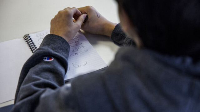 Des étudiants s'exercent à lire et à écrire la langue ouïghoure, à l'école de langue et de culture ouïghoure, à Fairfax, en Virginie aux États-Unis. Crédit photo: SAMUEL CORUM / AFP