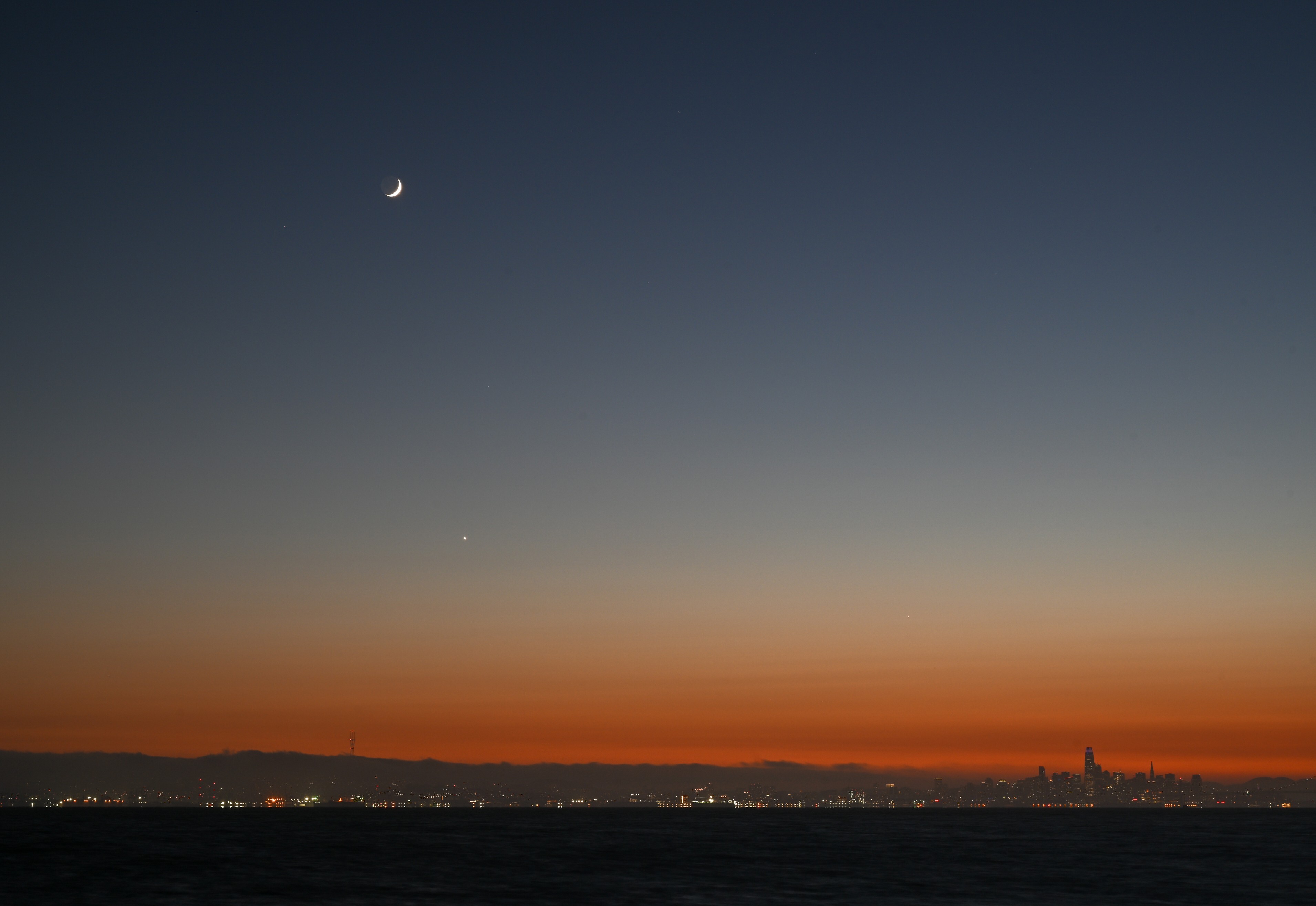 Crescent moon sets over the San Francisco Bay