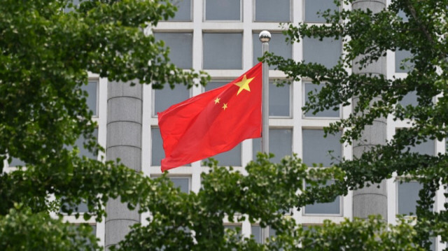 Le drapeau national chinois. Crédit photo: GREG BAKER / AFP