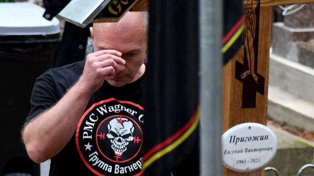 Un homme fait le signe de croix devant la tombe du chef du groupe mercenaire privé Wagner, Evguéni Prigojine, au cimetière de Porokhovskoye à Saint-Pétersbourg en Russie, le 30 août 2023. Crédit photo: OLGA MALTSEVA / AFP