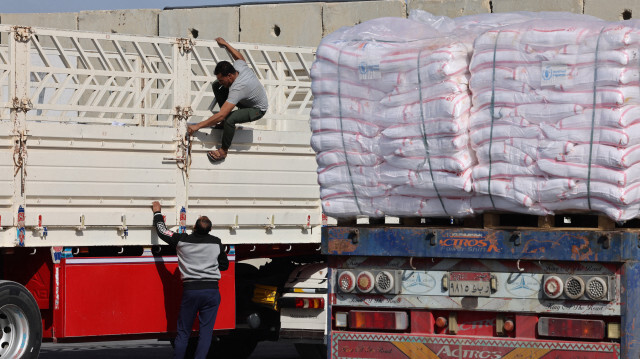 Un chauffeur de camion refermant sa cargaison d'aide humanitaire après avoir été inspecté par la sécurité israélienne à son arrivée d'Égypte, du côté israélien du poste frontière de Kerem Shalom avec le sud de la bande de Gaza, le 10 janvier 2024.