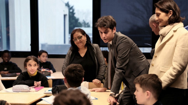 Le Premier ministre français Gabriel Attal aux côtés de la ministre française de l'Éducation, des Sports et des Jeux olympiques Amélie Oudea-Castera lors d'une visite au collège Saint-Exupery, à Andrésy, au nord-ouest de Paris, le 12 janvier 2024.