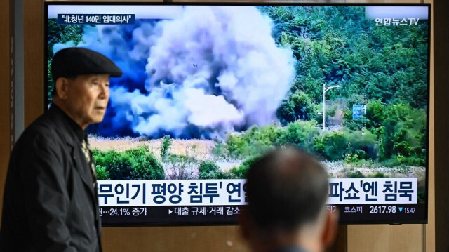 Un homme passe devant un écran de télévision diffusant des images d'une explosion sur une route reliant la Corée du Nord et la Corée du Sud le 15 octobre 2024, dans une gare de Séoul le 16 octobre 2024.