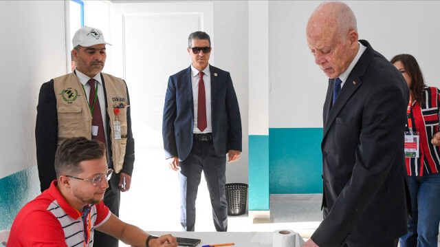 Cette photo diffusée par la présidence tunisienne montre le président tunisien Kais Saied trempant son doigt dans l'encre après avoir voté dans un bureau de vote lors des élections présidentielles de 2024 à Tunis, le 6 octobre 2024. Les électeurs se sont rendus aux urnes en Tunisie le 6 octobre pour une élection présidentielle qui devrait voir le président sortant Kais Saied s'assurer un nouveau mandat de cinq ans, alors que ses principaux détracteurs - dont un concurrent - sont derrière les barreaux.