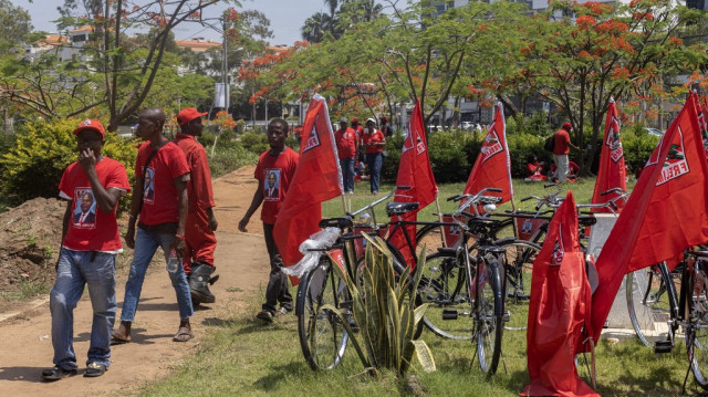 Des partisans du candidat à la présidence du Front de libération du Mozambique (FRELIMO), Daniel Chapo, passent devant des bicyclettes décorées de drapeaux du parti avant une marche pour célébrer la victoire électorale revendiquée par le parti après des semaines de manifestations dans le centre de Maputo, le 23 novembre 2024.