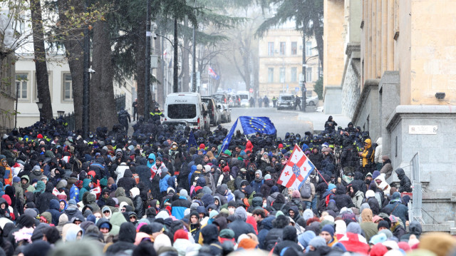 Des manifestants anti-gouvernementaux se rassemblent devant le bâtiment du parlement alors que les membres du parlement élisent un nouveau président à Tbilissi, le 14 décembre 2024. L'ex-footballeur géorgien Mikheil Kavelashvili, devenu politicien d'extrême droite, devrait devenir le prochain président de Tbilissi lors d'une élection indirecte samedi, dénoncée comme "illégitime" par l'actuel dirigeant pro-UE. Il devrait être élu par un collège électoral contrôlé par Rêve géorgien, après que le parti a aboli le recours au vote populaire pour élire le président en vertu de changements constitutionnels controversés adoptés en 2017.