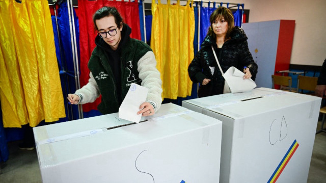 Des électeurs votent dans un bureau de vote à Bucarest, le 1er décembre 2024.