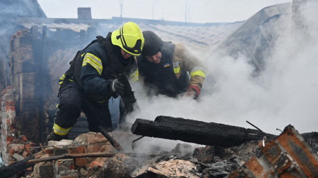 Des secouristes du service d'urgence de l'État éteignent un incendie dans une maison privée après une attaque de drone à Kharkiv, en Ukraine, le 25 décembre 2024.