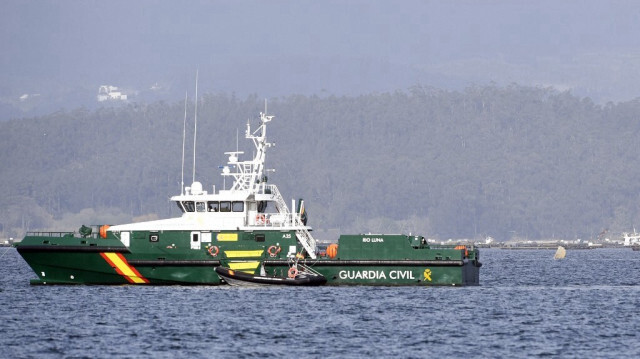 Un bateau de garde-côtes de la Garde civile navigue près de la proue d'un présumé narco-sous-marin dans l'estuaire de la Ria de Arousa à Villagarcia de Arousa, en Espagne, le 14 mars 2023.