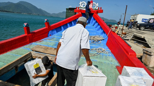 Les travailleurs chargent du matériel électoral sur un bateau se dirigeant vers des îles éloignées, à Pulo Aceh, à Banda Aceh, le 12 février 2024, avant les prochaines élections générales indonésiennes prévues le 14 février.