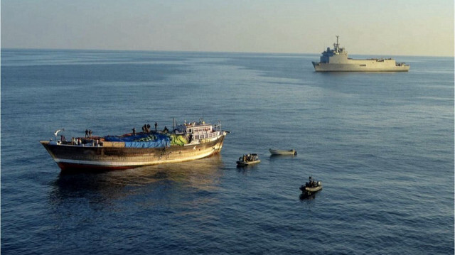 Cette photo publiée le 20 janvier 2014 montre l'équipage du navire amiral FS Siroco (à l'arrière-plan) de l'opération Atalanta de la force navale française de l'EU NAVFOR en Somalie, lors d'une opération visant à libérer l'équipage d'un boutre (à gauche) qui était soupçonné d'avoir été utilisé comme navire mère par des pirates. 