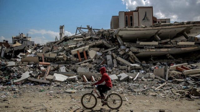 Un homme passe à vélo devant l'université al-Aqsa, détruite par les bombardements israéliens dans la ville de Gaza, le 15 février 2024.