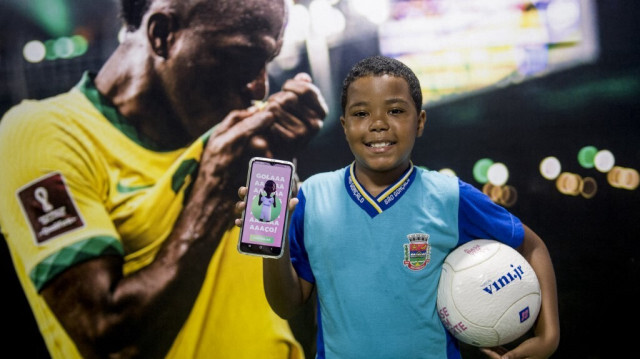 L'élève Yuri Rodrigues da Silva pose montrant l'application éducative de l'Institut Vini Jr à l'école municipale Visconde de Sepetiba à São Gonçalo, en périphérie de Rio de Janeiro, Brésil, le 27 février 2024.