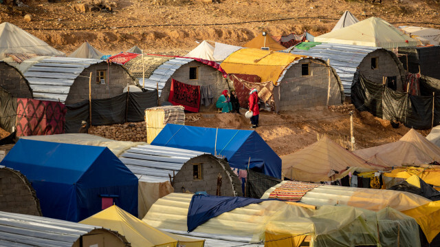 Des femmes discutant devant des huttes construites par des ONG marocaines et néerlandaises dans un camp près du village de Douzrou, dans le centre du Maroc, le 13 février 2024. Les autorités marocaines ont déclaré que quelque 3 000 personnes avaient trouvé la mort lors du tremblement de terre du 8 septembre, qui a détruit plus de 60 000 habitations.
