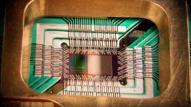 Puce construite pour fonctionner comme un processeur d'optimisation quantique adiabatique supraconducteur de 128 qubits, monté dans un porte-échantillons.