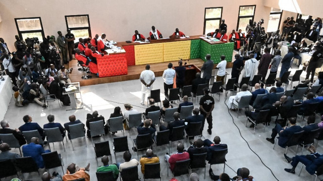 Les onze accusés se tiennent debout alors que la session débute dans le nouveau palais de justice de Conakry le 28 septembre 2022 pour le procès du massacre de 156 personnes en septembre 2009.