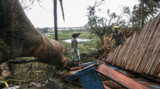 Un homme tente de déblayer les décombres d'une maison après le passage du cyclone Batsirai, dans le district de Tanambao, le 8 février 2022 à Mananjary au Madagascar. 