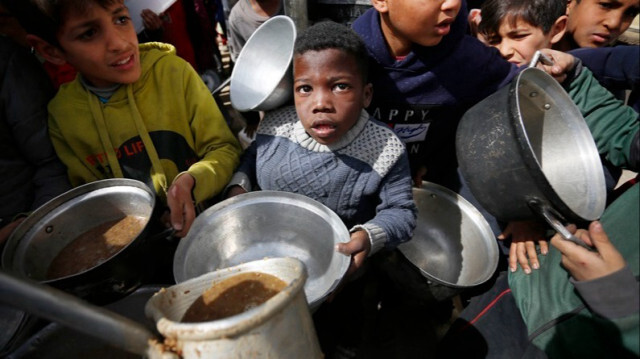Les enfants Palestiniens font la queue pendant des heures pour recevoir de la nourriture distribuée par des organisations caritatives à Gaza. Photo prise le 1er mars 2024.