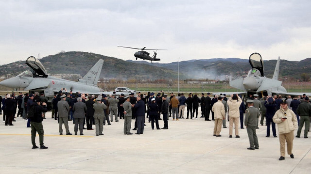 Des politiciens et des militaires près des avions de chasse Typhoon de l'armée de l'air italienne lors d'une cérémonie à la base aérienne récemment rénovée et soutenue par l'OTAN dans la ville albanaise de Kucova, à 90 kilomètres au sud de la capitale Tirana, le 4 mars 2024.