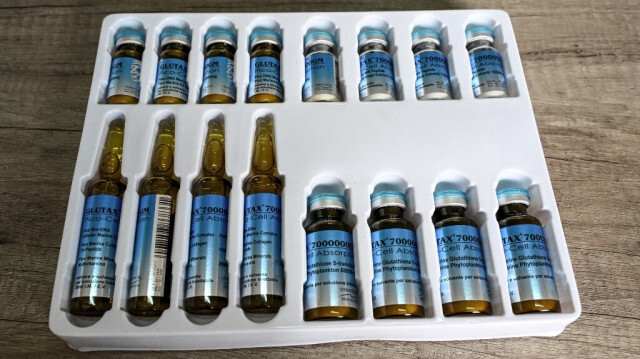 Des flacons de produits vendus comme le glutathion injectable blanchissant sont exposés à Abidjan le 13 décembre 2023 Ces dernières années, à côté des pommades, des ampoules et des flacons ont fait leur apparition dans les rayons. 