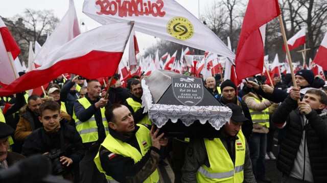 Des agriculteurs polonais portent un cercueil portant l'inscription "Agriculture polonaise 2004 - 2024" lors d'une manifestation contre les mesures climatiques de l'UE et les importations ukrainiennes, le 6 mars 2024 à Varsovie, en Pologne.