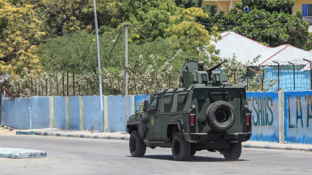 Un véhicule blindé de transport de troupes (APC) roule dans une rue près d'un hôtel à Mogadiscio le 15 mars 2024. 