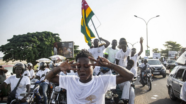 Des partisans du parti d'opposition Dynamique pour la Majorité du Peuple (DMP) se réjouissent alors qu'ils font campagne dans les rues de Lomé, le 27 avril 2024. 