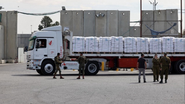 Les forces de sécurité israéliennes se tiennent près d'un camion transportant de l'aide humanitaire destinée à Gaza.