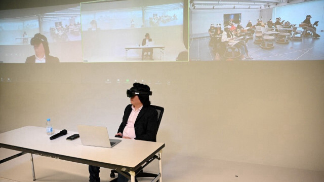 Pan Hui, professeur dirigeant un projet sur l'enseignement de l'IA à l'université des sciences et technologies de Hong Kong (HKUST), portant un casque de réalité virtuelle alors qu'il donne un cours à l'université de Hong Kong, le le 9 avril 2024.