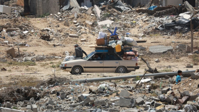 Des Palestiniens déplacés arrivent dans une voiture avec leurs affaires pour s'installer dans un abri après leur retour à Khan Yunis, dans le sud de la bande de Gaza, le 9 mai 2024.