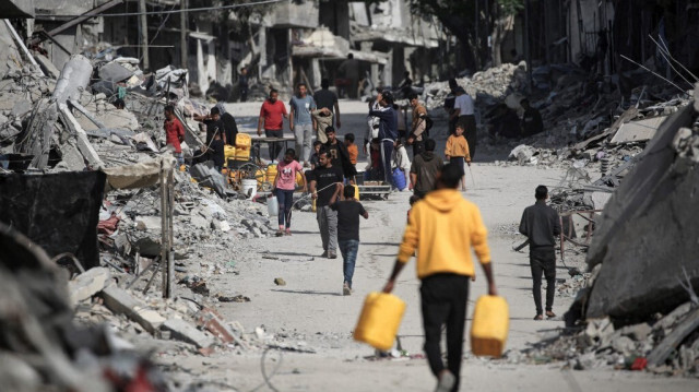 Des Palestiniens déplacés se rassemblent à un point d'eau pour remplir leurs jerricans à Khan Yunis, dans le sud de la bande de Gaza, le 16 mai 2024.