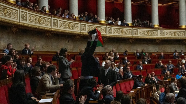 Le député français de La France Insoumise (LFI) Sébastien Delogu brandit un drapeau national palestinien lors de la séance des questions au gouvernement à l'Assemblée nationale à Paris le 28 mai 2024. 