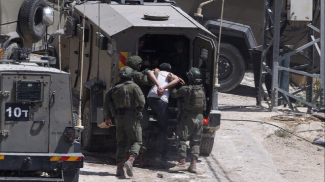 Des soldats israéliens arrêtent un Palestinien lors d'un raid en Palestine occupée.