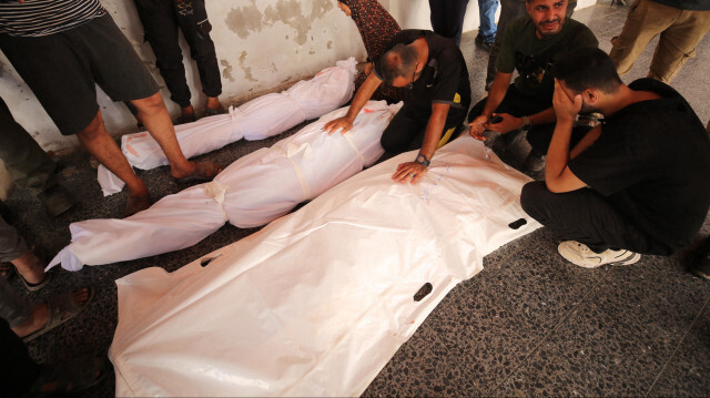 Les corps des Palestiniens décédés après les attaques israéliennes près d'un centre où les coupons d'aide sont distribués dans la Bande de Gaza, le 11 juin 2024.