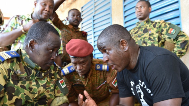 Le lieutenant-colonel Yacouba Isaac Zida (g) Guy Hervé Kam (d), avocat du mouvement "le ballet citoyen" discutent dans un camp militaire à Ouagadougou le 31 octobre 2014. 