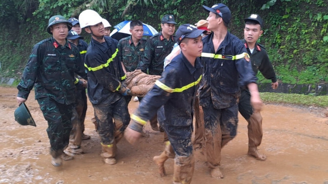 Des secouristes en train de transporter une victime à Ha Giang, Vietnam, le 13 juillet 2024.