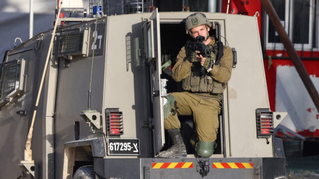 Un soldat de l'armée d'occupation israélienne pointe son fusil lors d'une attaque dans le camp de réfugiés de Nur Shams en Palestine occupée, le 19 avril 2024.