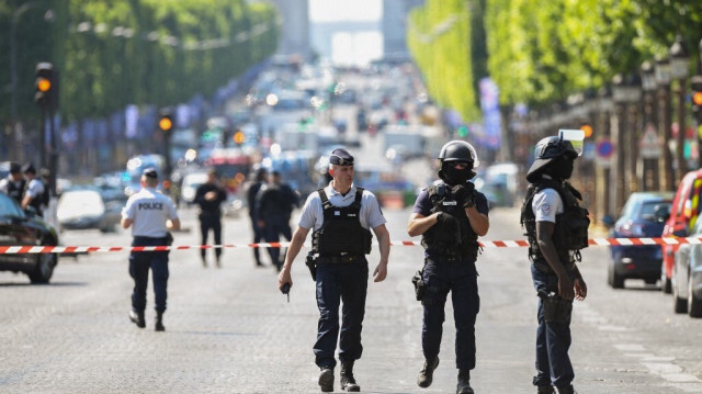 Des policiers et des agents anti-émeutes patrouillent sur l'avenue des Champs-Elysées le 19 juin 2017 à Paris, après qu'une voiture ait percuté un fourgon de police.