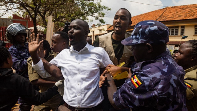 Des membres de la police ougandaise arrêtent des manifestants qui se dirigent vers le parlement lors d'une manifestation anti-corruption prévue à Kampala le 23 juillet 2024. 